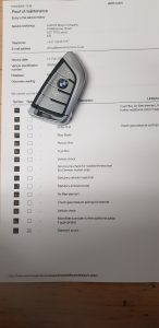 BMW car key on vehicle service history document