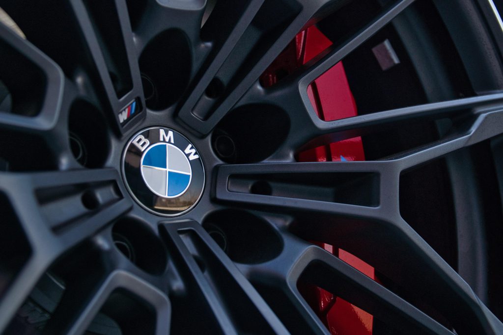 Close-up of a BMW alloy wheel with a red brake caliper behind the spokes